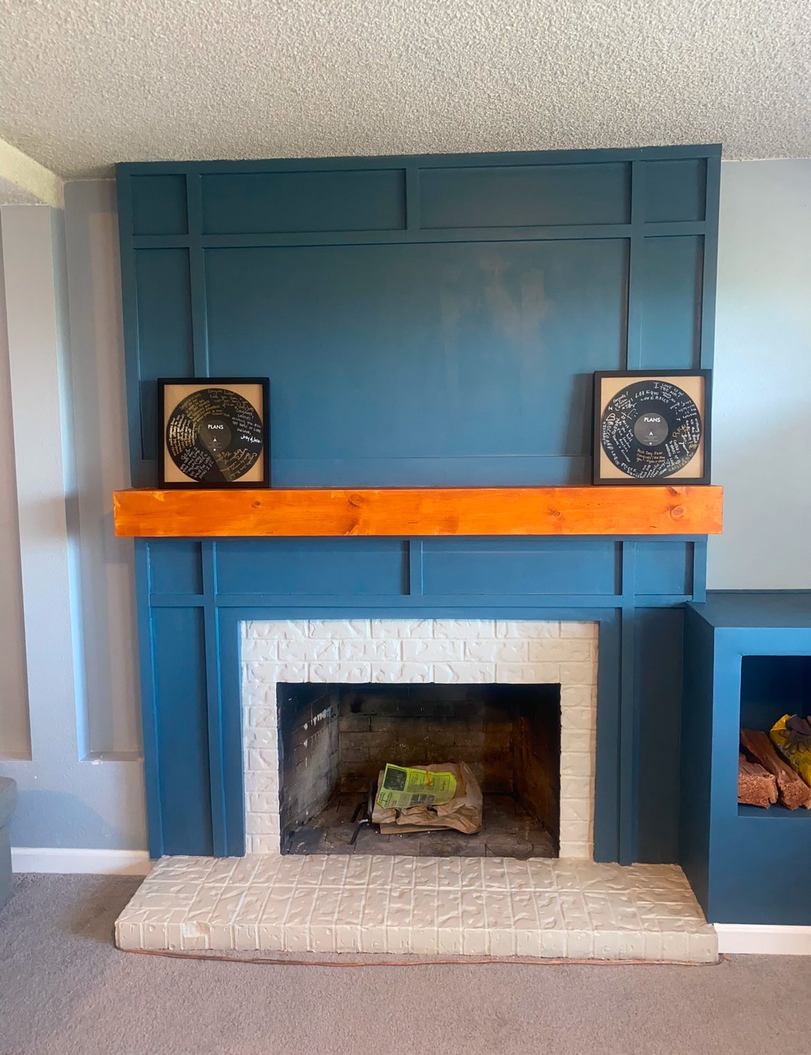 Board-and-batten fireplace surround with cedar mantel