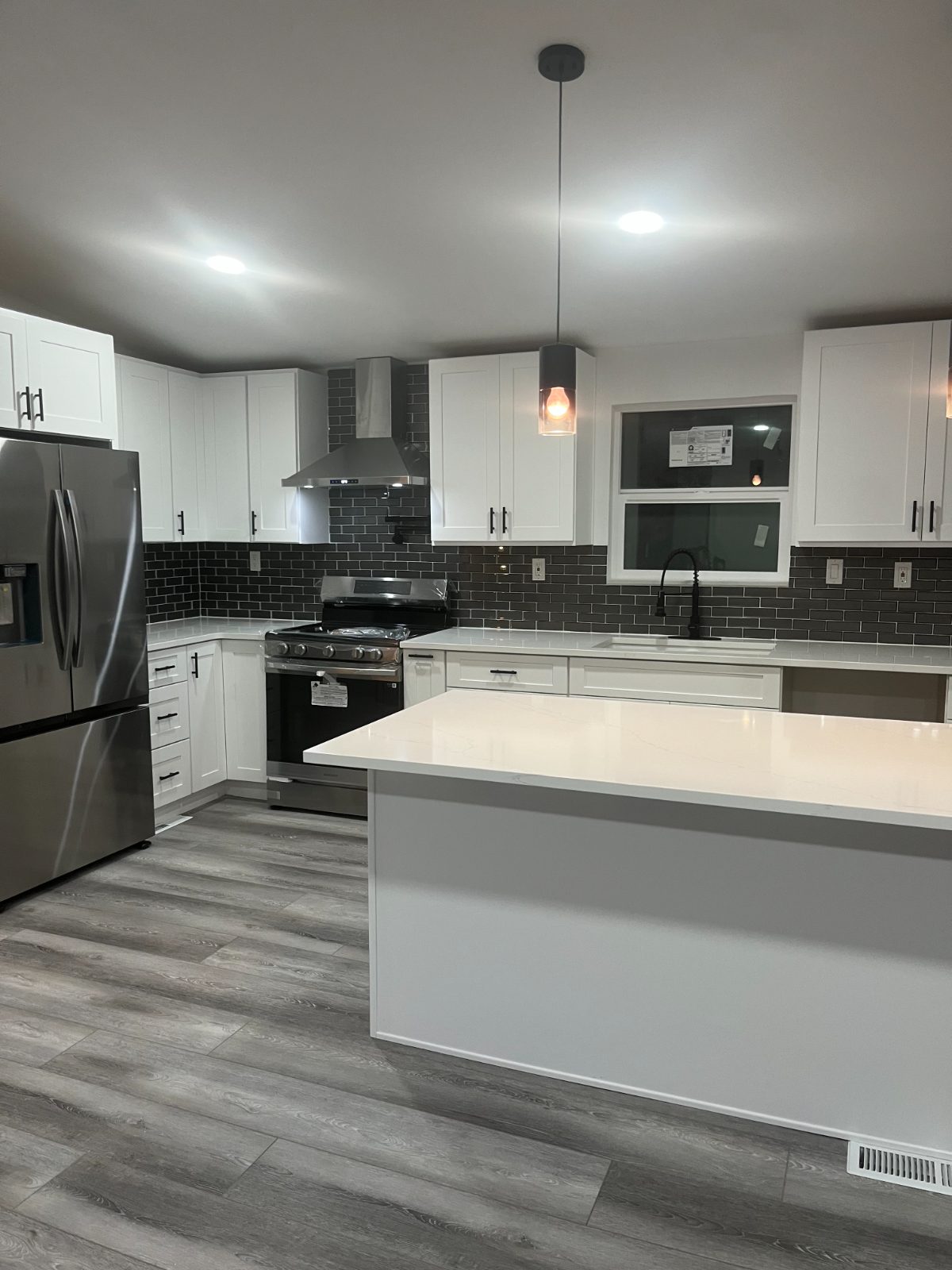 White kitchen with dark subway tile backsplash