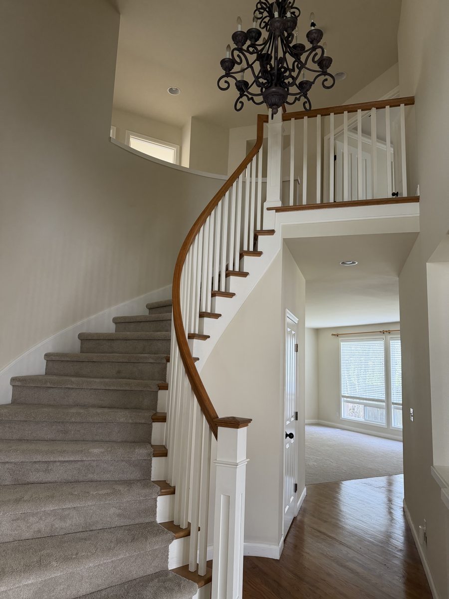 Curved staircase with refinished railing and fresh interior paint